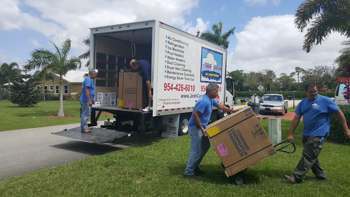 Jireh Cooler team unloading new HVAC equipment from a service truck