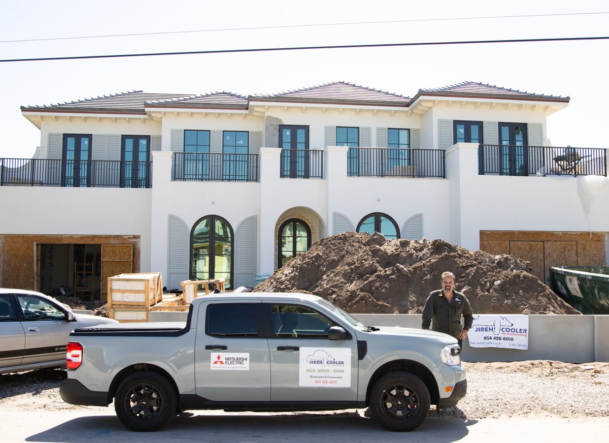 Jireh Cooler service truck outside a luxury new-construction home in South Florida