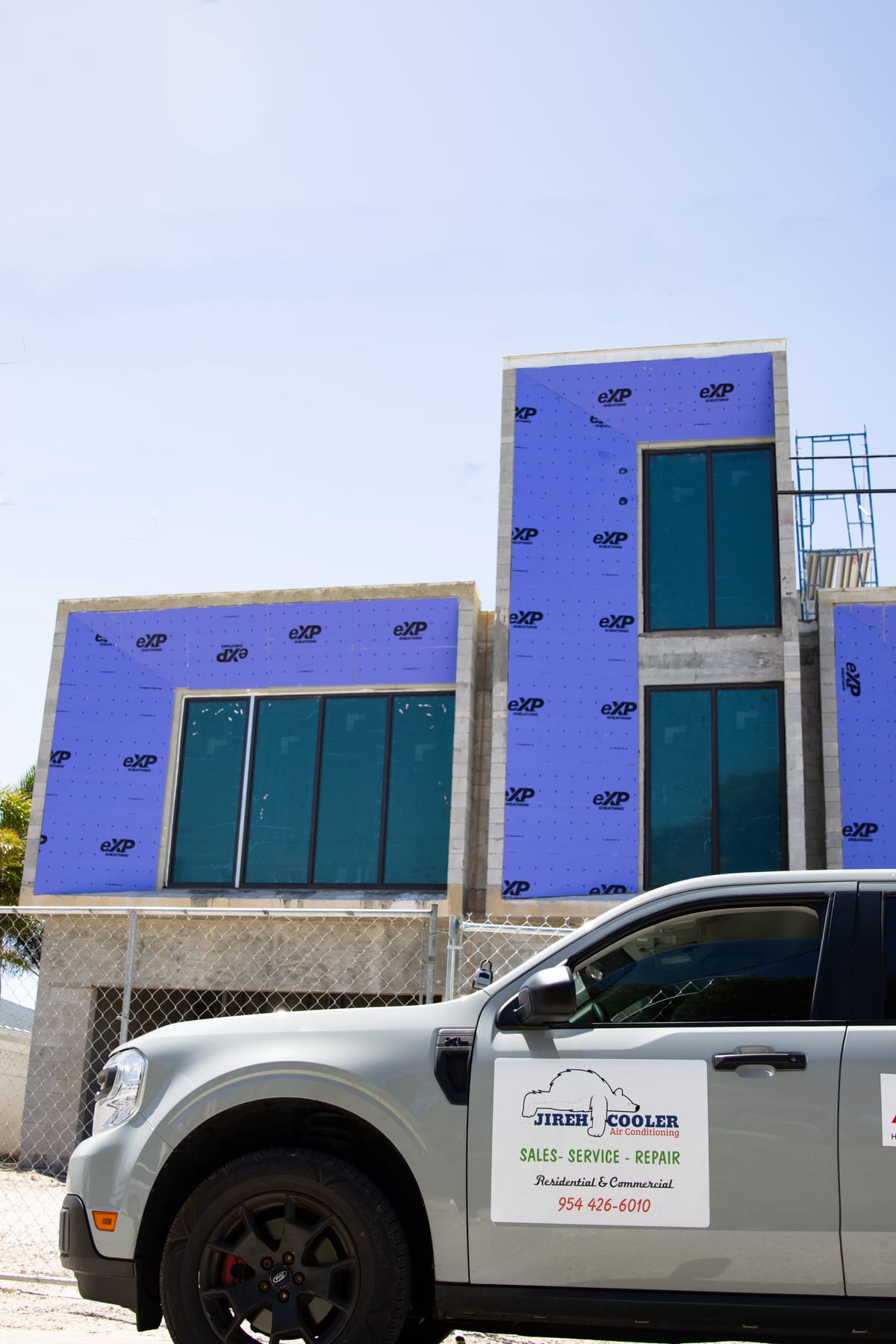 Jireh Cooler vehicle at a modern South Florida commercial construction project