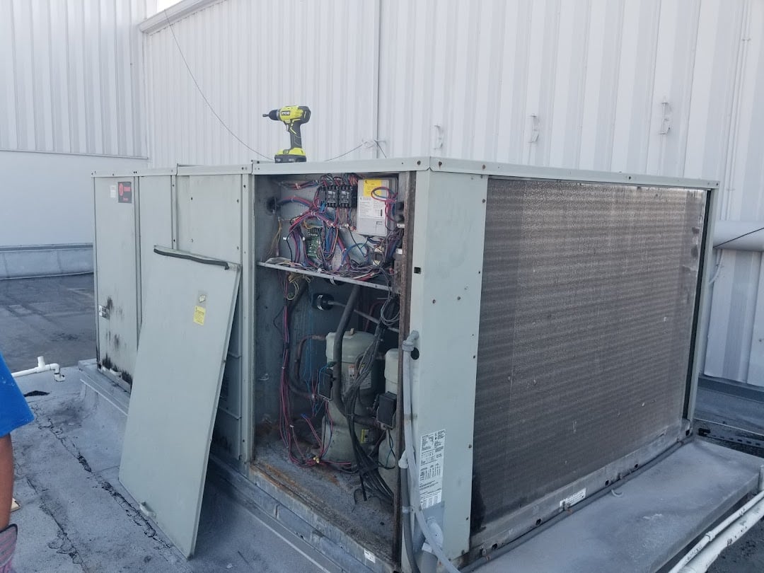 Jireh Cooler technician repairing a commercial rooftop package unit