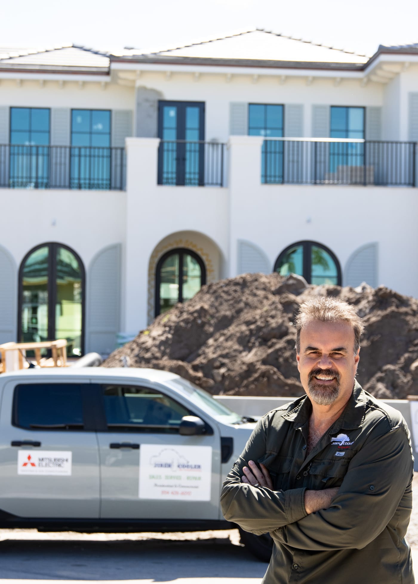 Jireh Cooler founder with a company van at a South Florida residential project