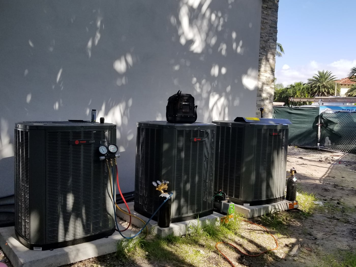 Jireh Cooler technician servicing a newly installed multi-system residential AC setup